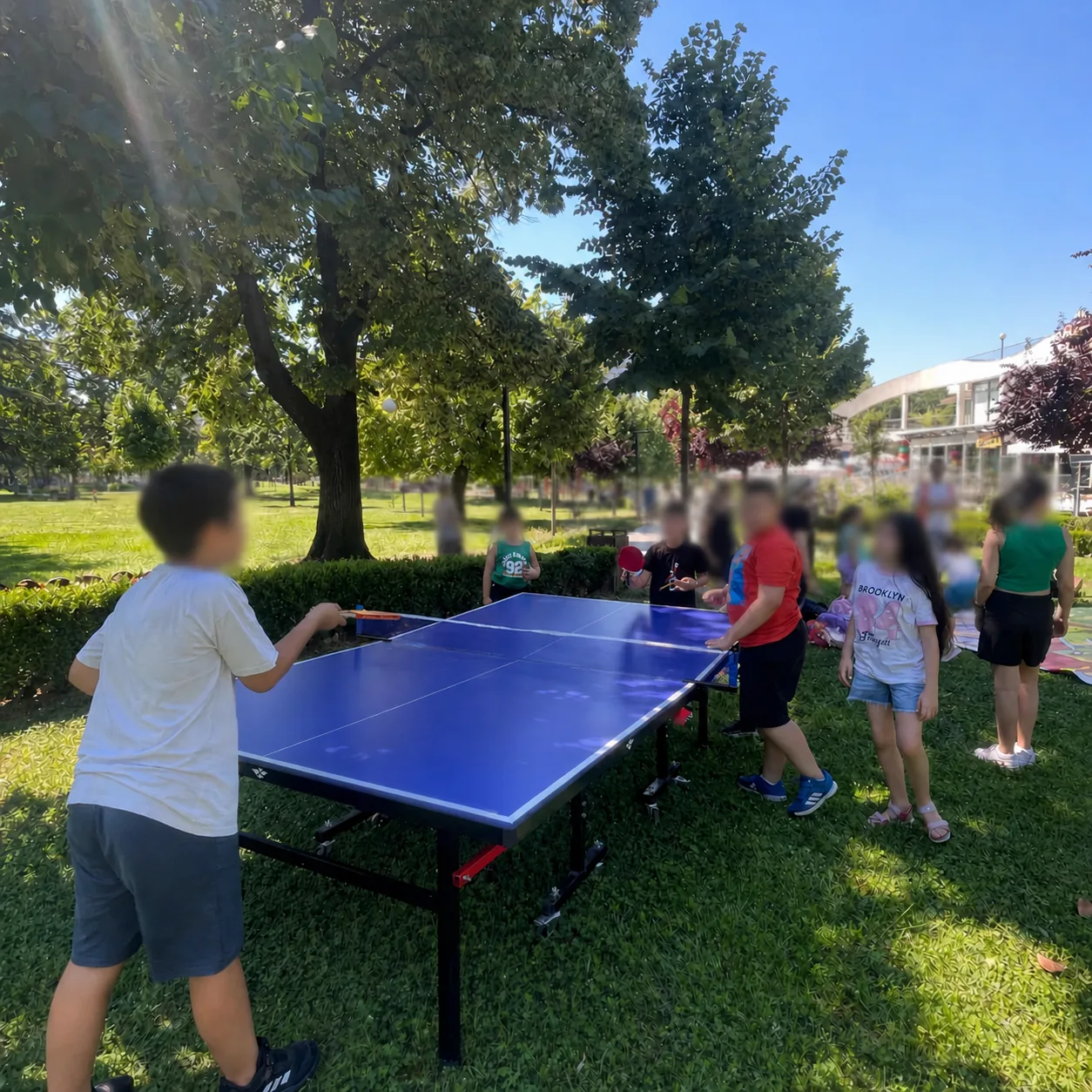 Children playing table tennis during a LU-EM summer activity